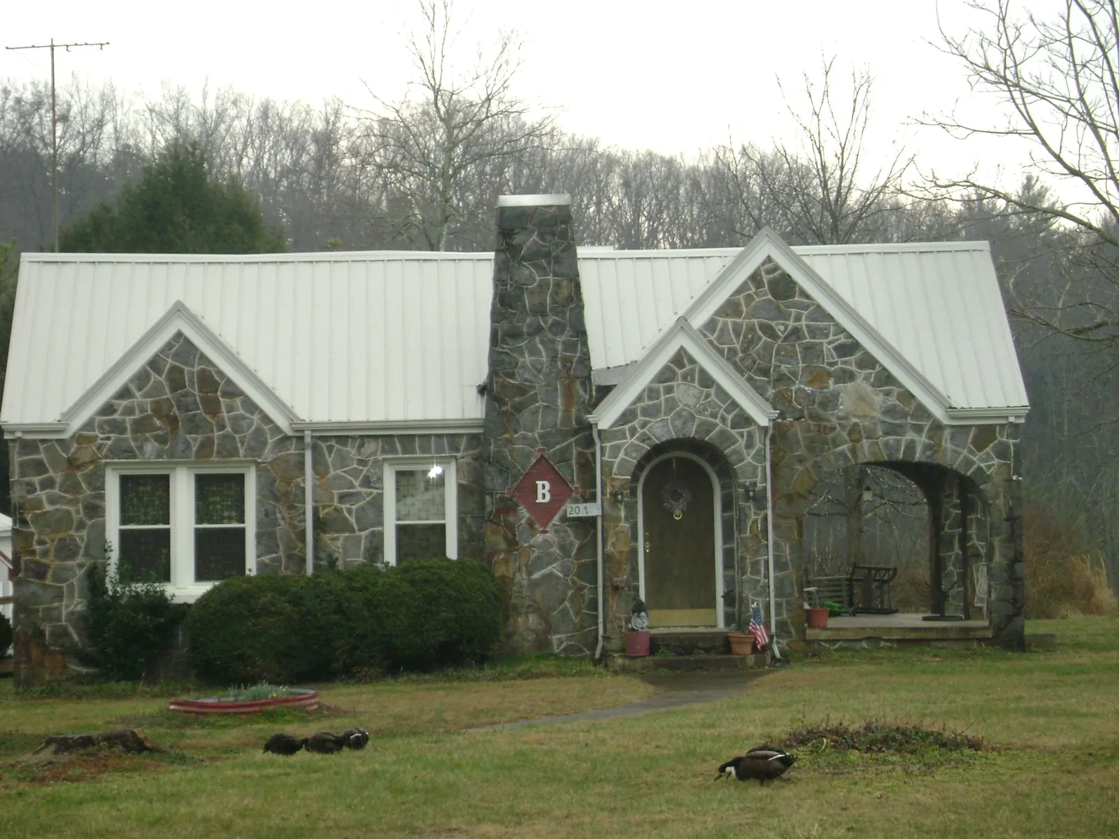 White metal roof on a stone cottage with steep gables in Ferndale